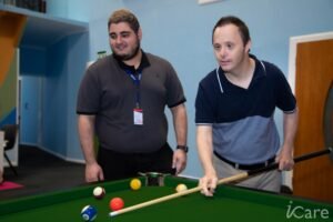 iCare Participant playing pool